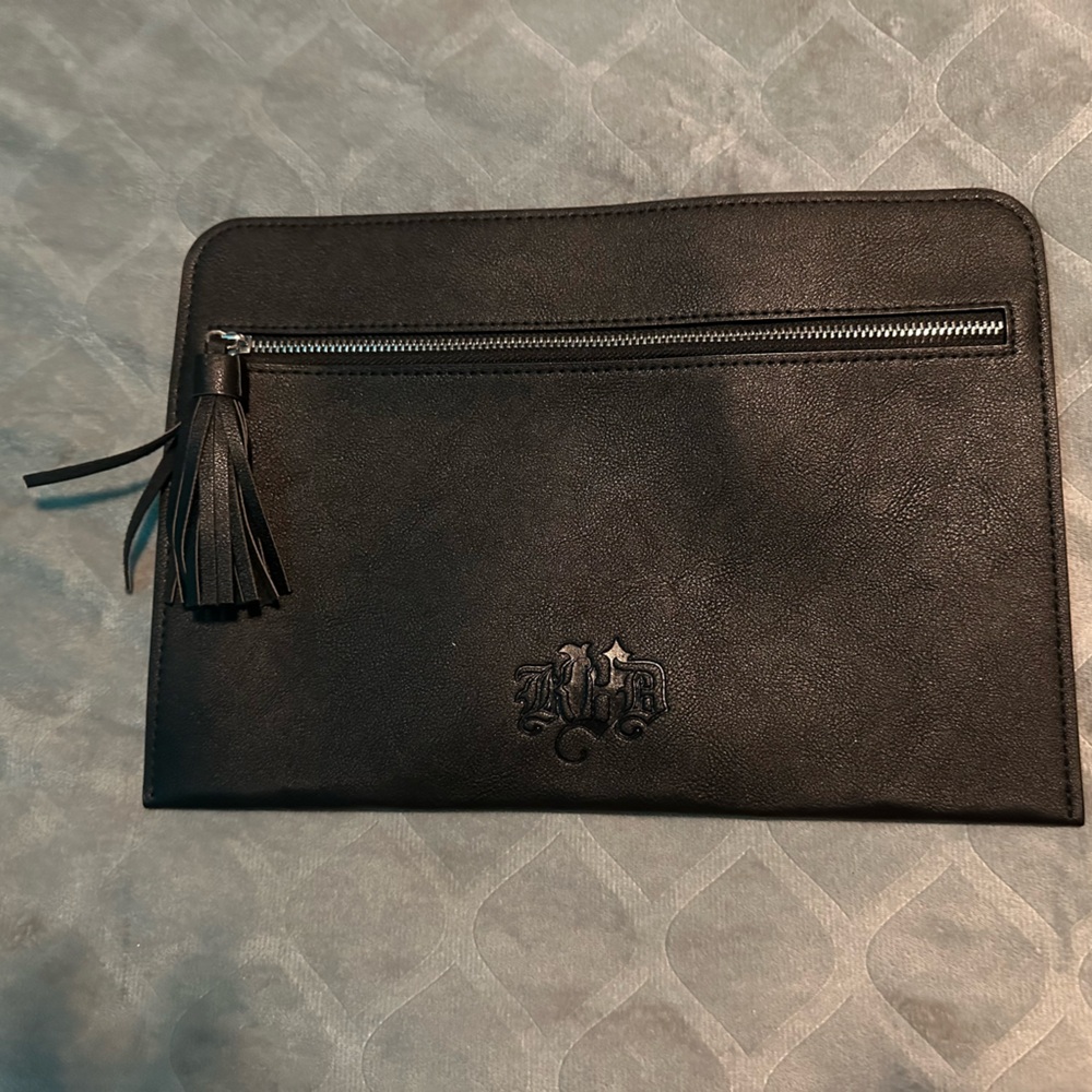 KVD Black, NWOT, never used make up bag. Front zipper pocket with black tassel.